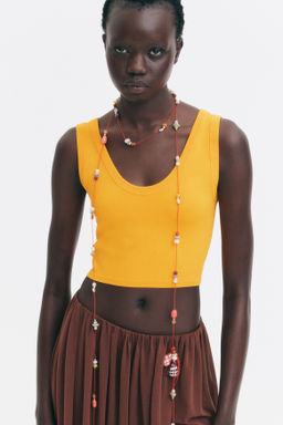 Top cropped sin mangas en punto fino - H&m фото 7