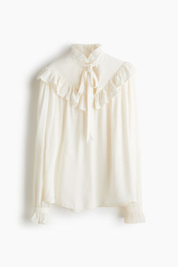Blusa con ribetes de volante