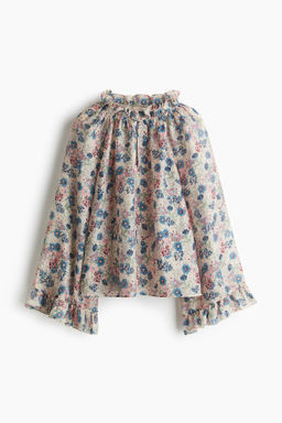 Blusa con ribetes de volante