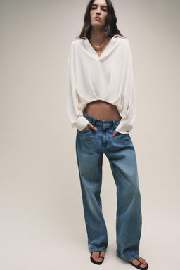 SHIRT WITH ASYMMETRIC HEM AND PLEATS