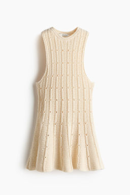 Top en punto pointelle con peplum