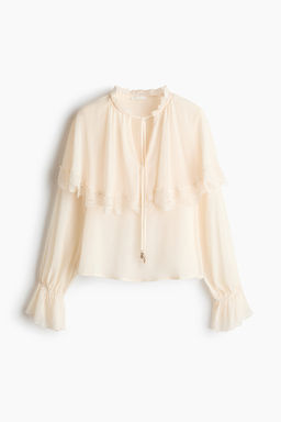 Blusa con capa decorativa