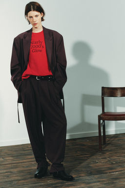 PLEATED TROUSERS WITH BUTTON HEM