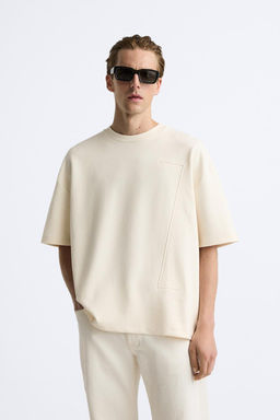 T-SHIRT WITH EMBOSSED SLOGAN