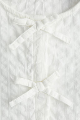 Blusa en sirsaca de algod?n con peplum
