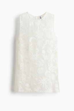 Top de rejilla con motivos decorativos