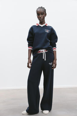 TROUSERS WITH EMBROIDERED SLOGAN