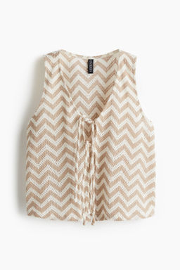 Chaleco en punto jacquard con lazada
