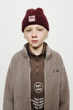 FAUX SHEARLING JACKET WITH EMBROIDERED TEXT