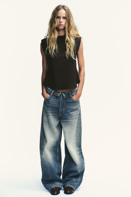 CREPE PEPLUM TOP WITH SHOULDER PADS