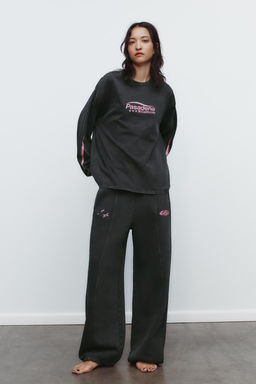 WASHED EFFECT PLUSH TROUSERS WITH SLOGAN