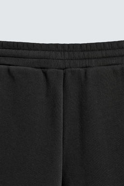 NEOPRENE-EFFECT PLEATED BALLOON FIT TROUSERS