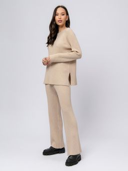 Брюки трикотажные бежевого цвета расклешенные