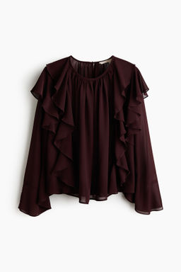 Blusa transparente con ribetes de volante