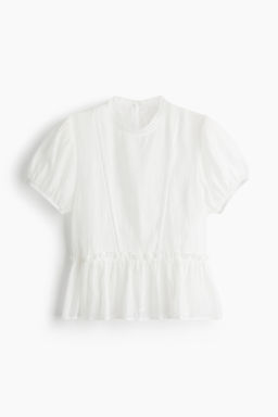 Blusa con inserciones de encaje y peplum