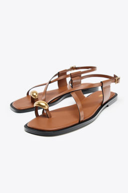FLAT SANDALS WITH METAL TOE DETAIL