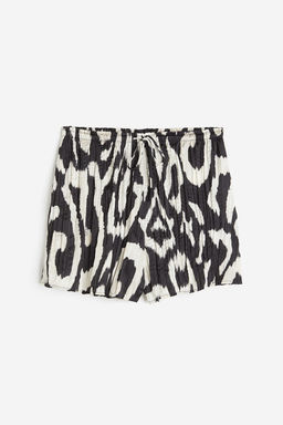 Pantalon corto plisado en saten