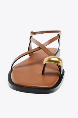 FLAT SANDALS WITH METAL TOE DETAIL