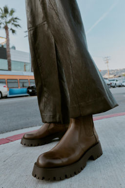 DISTRESSED-EFFECT TRACK-SOLE ANKLE BOOTS