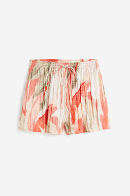 Pantalon corto plisado en saten