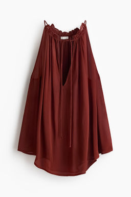 Top oversize con cord?n de ajuste