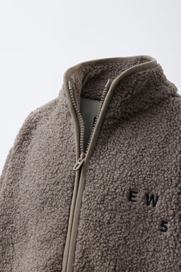 FAUX SHEARLING JACKET WITH EMBROIDERED TEXT