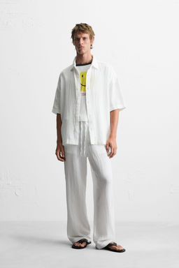 CRINKLED-EFFECT TROUSERS
