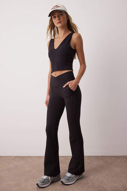 Siyah Soft F?rcal? Kumas Kruvaze Bel ve Cep Detayl? Ispanyol Paca Yoga Orme Spor Tayt THMAW26TY00000