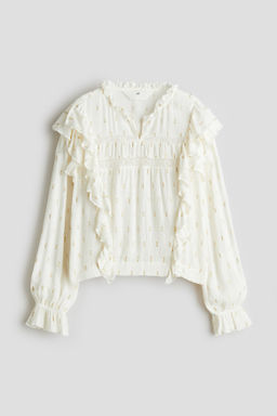 Blusa con ribetes de volante