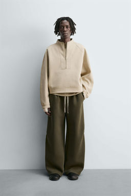 WIDE-LEG NEOPRENE-EFFECT TROUSERS WITH STUDS