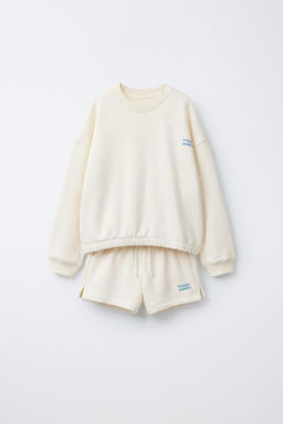 CONJUNTO SUDADERA Y BERMUDA TEXTO / Crudo