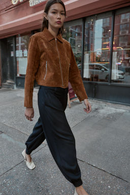 PLEATED TROUSERS WITH BUTTONED HEM