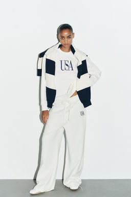 COTTON EMBROIDERED TEXT TROUSERS
