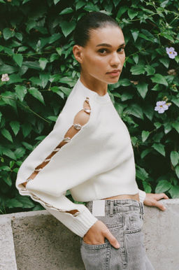 KNITTED SWEATER WITH BALL DETAIL