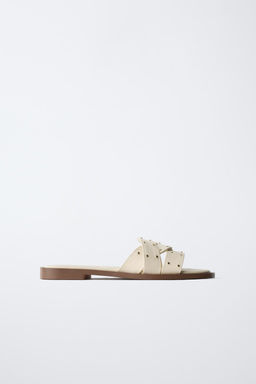 FLAT CRISS-CROSS SANDALS WITH STUDS