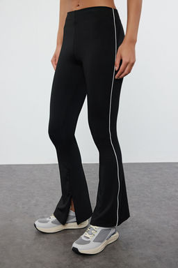 TRENDYOLMILLA Siyah Toparlay?c? Biye ve Fermuar Detayl? Ispanyol Paca Yoga Orme Spor Tayt THMAW25TY00001