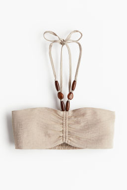 Top de playa con cuentas decorativas