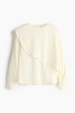 Blusa con capa decorativa