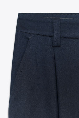 PLEATED TROUSERS WITH BUTTONED HEM