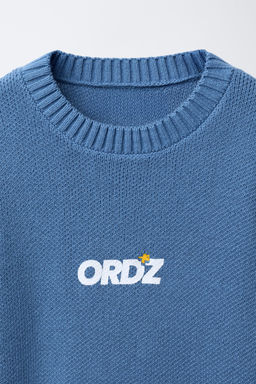 KNIT SWEATER WITH SLOGAN