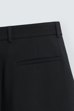 RELAXED FIT PLEATED TROUSERS