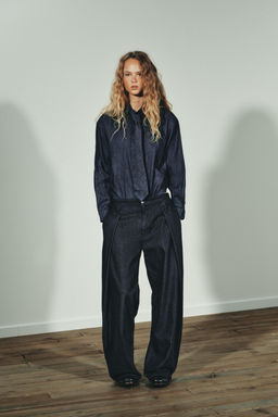 PLEATED DENIM-EFFECT TROUSERS