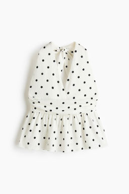 Top halter con peplum