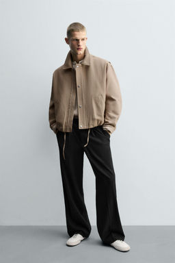 PLEATED TEXTURED TROUSERS