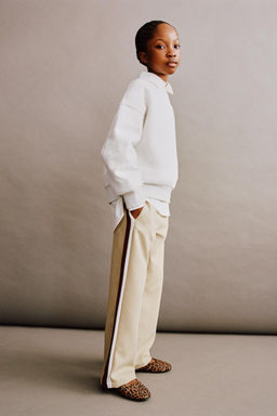 TROUSERS WITH SIDE TAPING