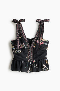 Top con tirantes de lazo y peplum