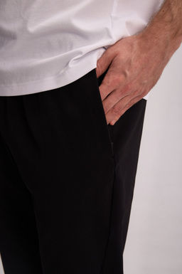 Брюки текстильные Черный TRN Woven Track Pants - Anta фото 6