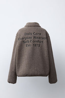 FAUX SHEARLING JACKET WITH EMBROIDERED TEXT