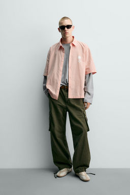 CAMISA BOXY FIT TEXTOS ESTAMPADOS / blanco-naranja