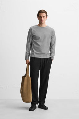 TEXTURED PLEATED TROUSERS
